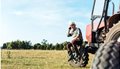 stock-photo-selective-focus-agronomist-talking-smartphone-tractor