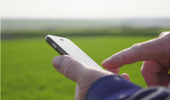 videoblocks-agronomist-mature-man-using-smartphone-in-agriculture-farm-close-up-farmer-with-mobile-phone-in-hands-in-the-field_b40gjtmsn_thumbnail-1080_01_2_2