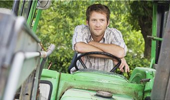 young-farmer-in-tractor-cab-photo-WestEnd61-REX-Shutterstock