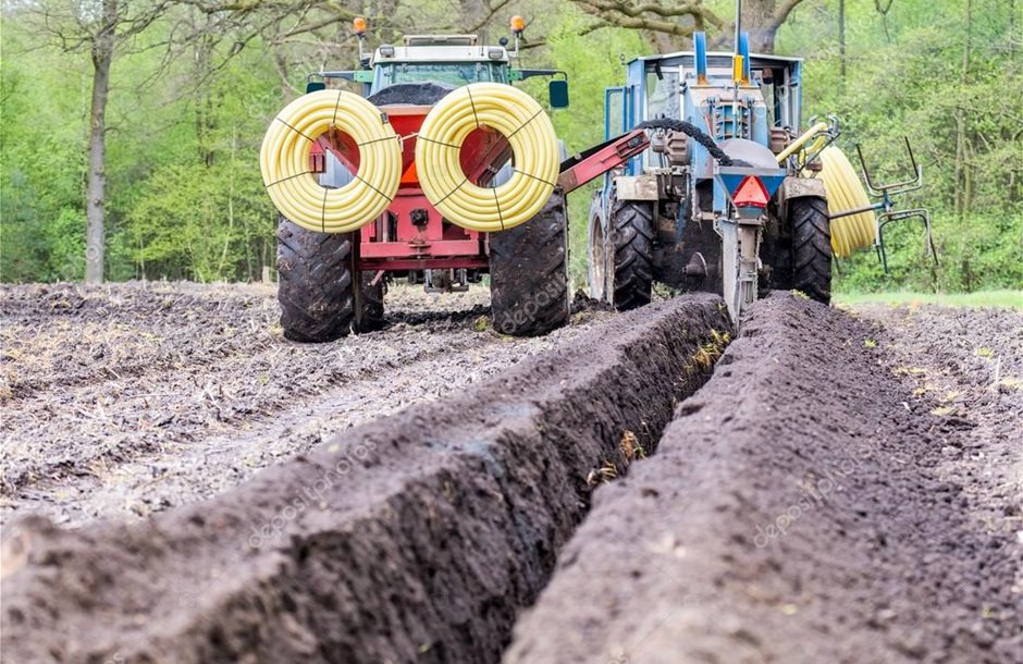depositphotos_76593097-stock-photo-two-agriculture-tractors-putting-drainage