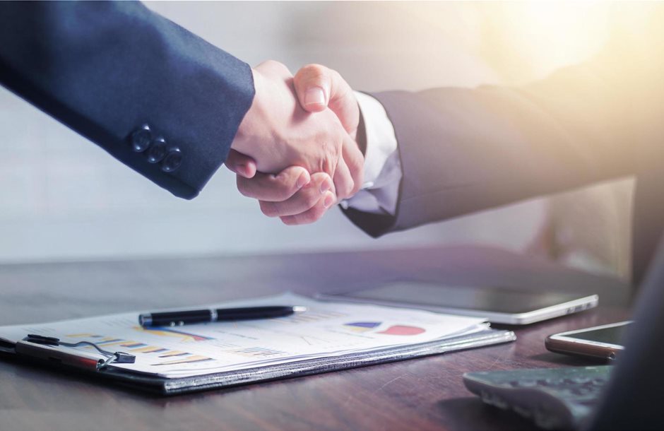 two-businessmen-shake-hands-to-celebrate-a-business-deal-free-photo